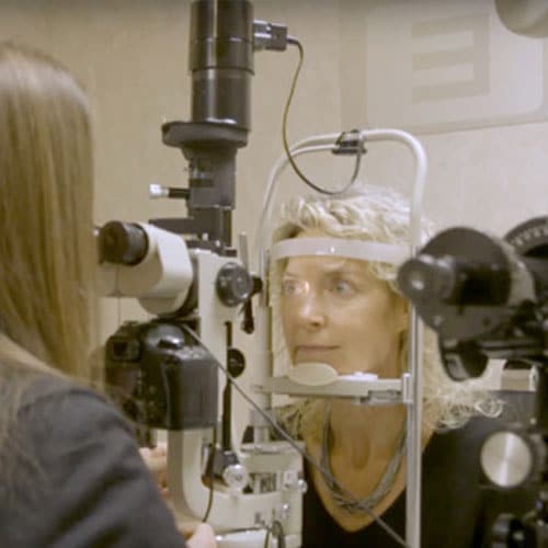 an eye dr examining a woman's eye