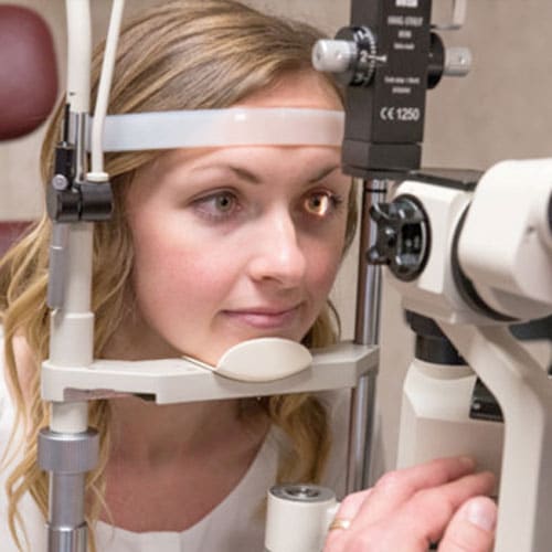 a woman having her eye examined as part of our comprehensive eye care services