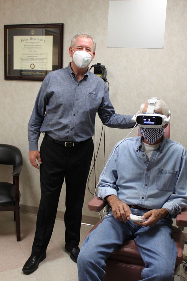 dr kirman with a patient who is wearing an adaptdx pro instrument device